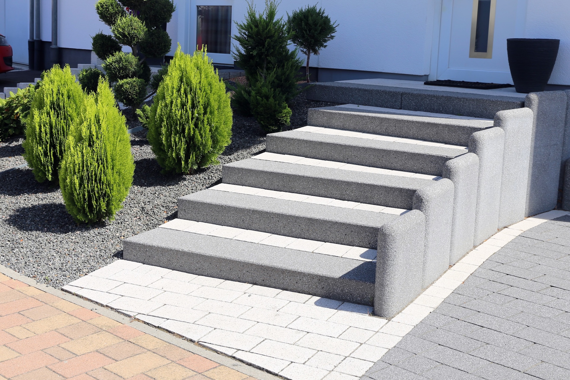 Neat and tidy front yard with solid block steps, decorative gravel and planting Neat and tidy front yard with solid block steps, decorative gravel and planting